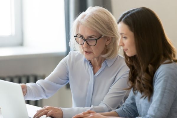 two women looking at laptop