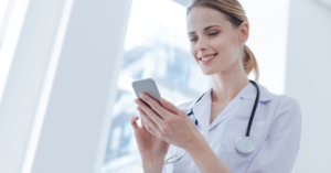 woman in labcoat looking at phone