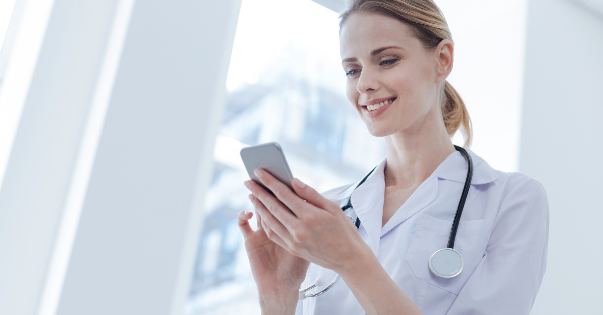 woman in labcoat looking at phone